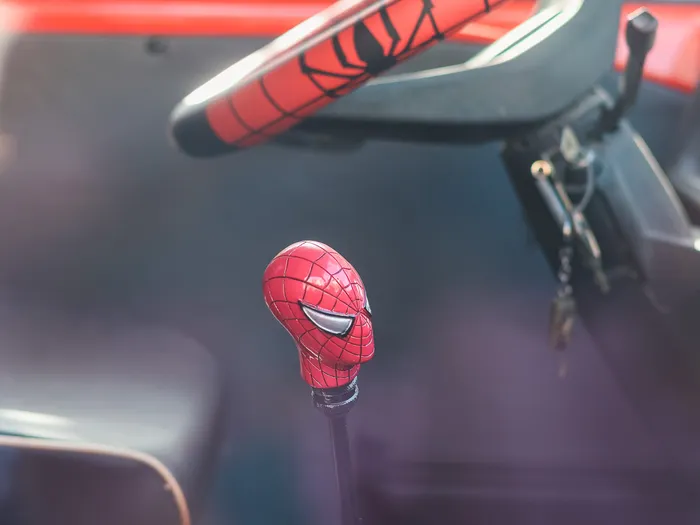 Spider-Man mask gear knob and web-patterned steering wheel in the cab of the FAN-tastic Food Truck at Disneyland Paris