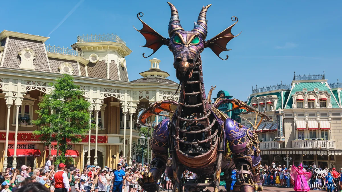 Maleficent’s purple mechanical dragon in Disney Stars on Parade on Main Street U.S.A. at Disneyland Paris, in front of the crowd