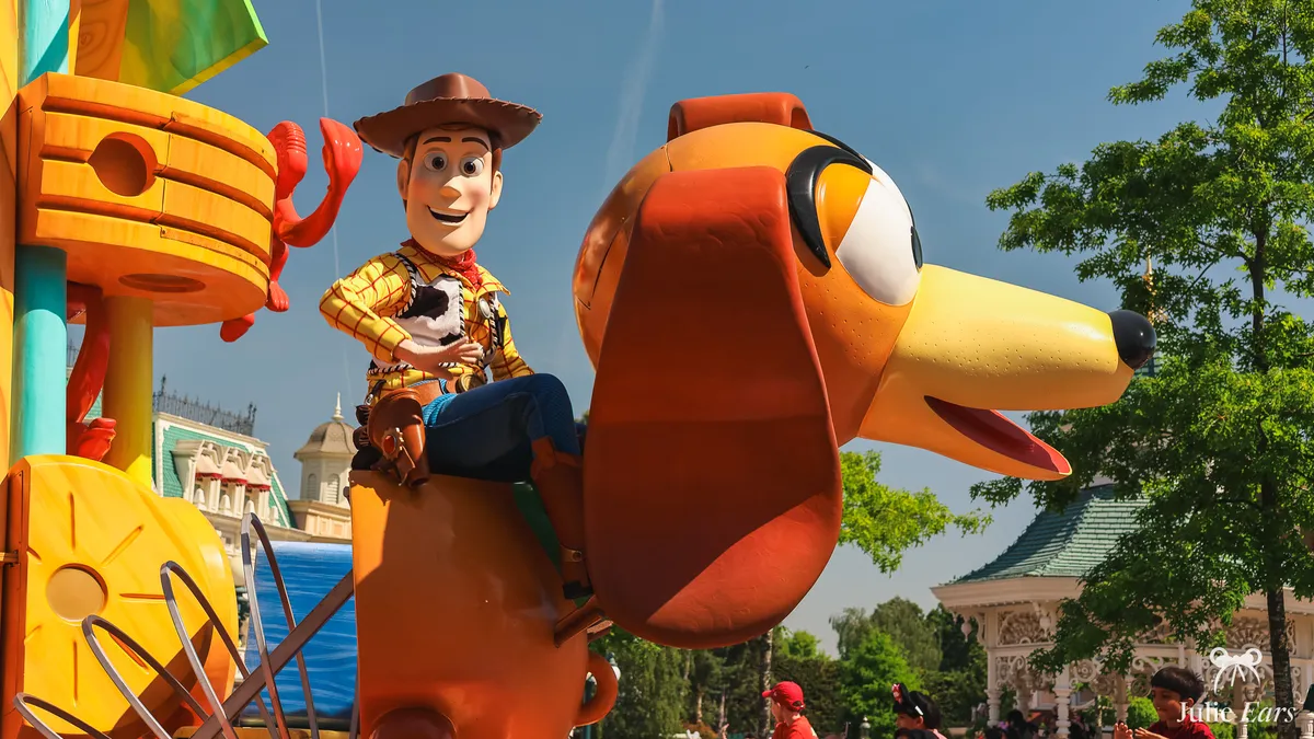 Woody from Toy Story riding Slinky Dog on his Disney Stars on Parade float, by the Town Square bandstand on Main Street U.S.A., Disneyland Paris