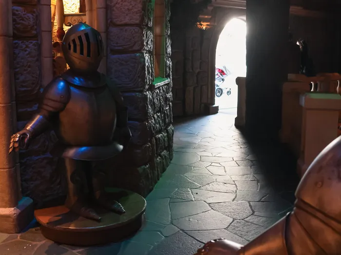 Suits of armour framing a passageway in La Chaumière des Sept Nains at Disneyland Paris.