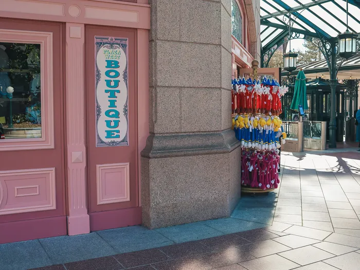Pink facade of the Plaza West Boutique with a display of colourful souvenirs under the covered arcade
