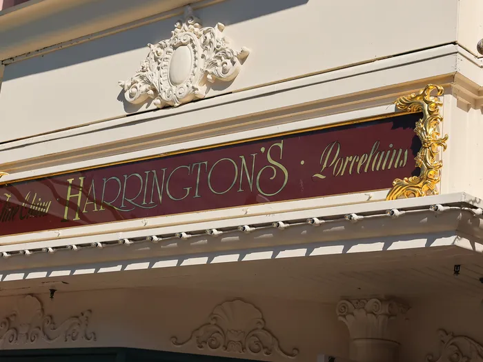 Outdoor "Harrington’s · Porcelains" sign on the shop facade at Disneyland Paris.
