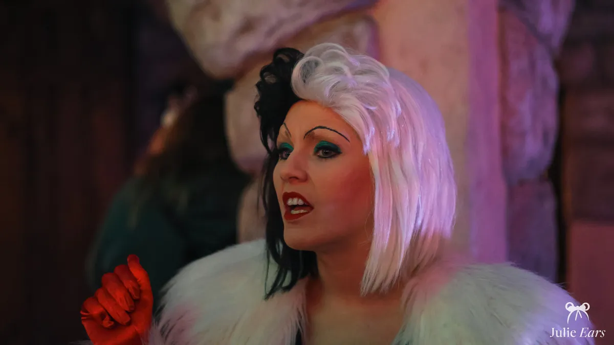 Cruella de Vil, with her half-white, half-black hair, fur coat and red glove, during a show at Disneyland Paris.