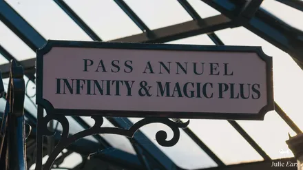 Infinity and Magic Plus annual pass plaque on ornate black ironwork, at the entrance reserved for these annual passes at Disneyland Paris.