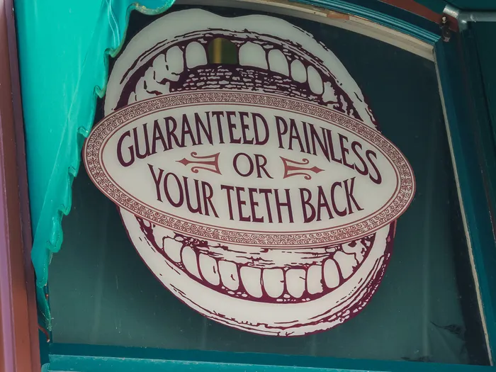 Dentist window gag guaranteeing painless care, or you get your teeth back, on Main Street U.S.A.