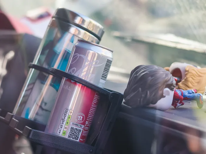Can and cup on the dashboard of the FAN-tastic Food Truck at Disneyland Paris, next to Marvel superhero figures