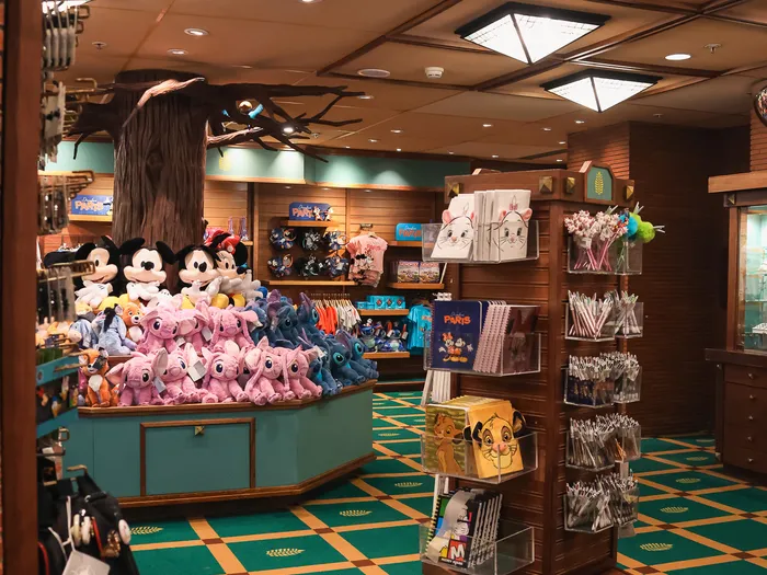 Interior view with a central bin of Mickey and Stitch soft toys and a rotating pen stand