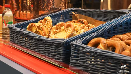 Baskets of pretzels at the Alsace chalet of the food festival, with the mulled wine pot in the background.