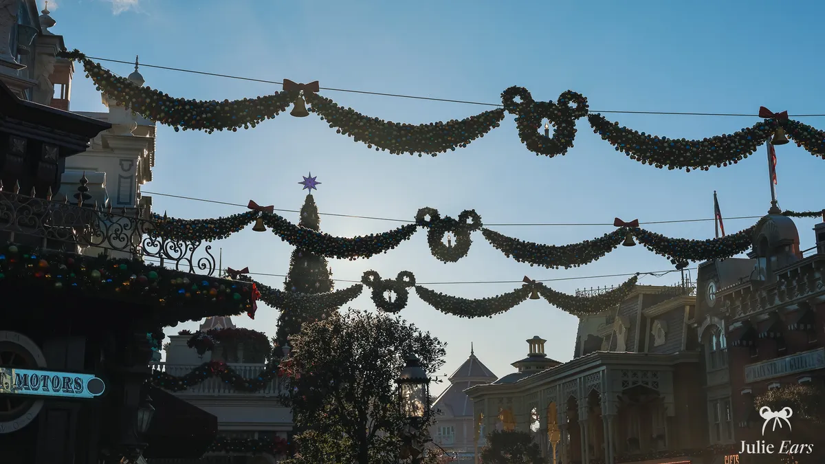 Christmas garlands with baubles, bells and Mickey-shaped wreaths hanging above Main Street U.S.A. at Disneyland Paris
