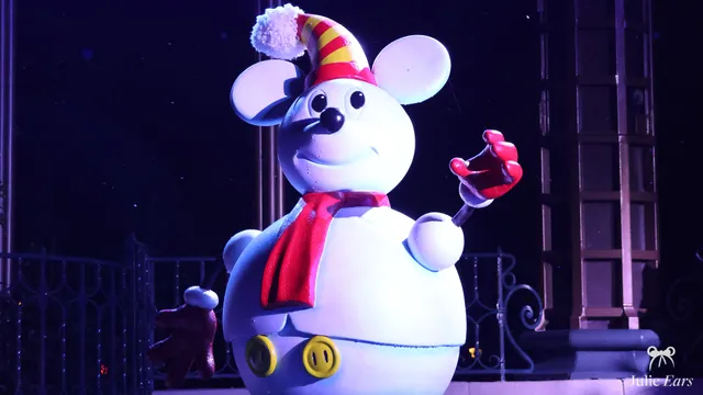 Large decoration of Mickey as a snowman, in a striped hat and red scarf, during the Christmas season at Disneyland Paris
