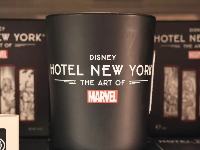 Black Disney Hotel New York - The Art of Marvel candle on a shelf in the shop