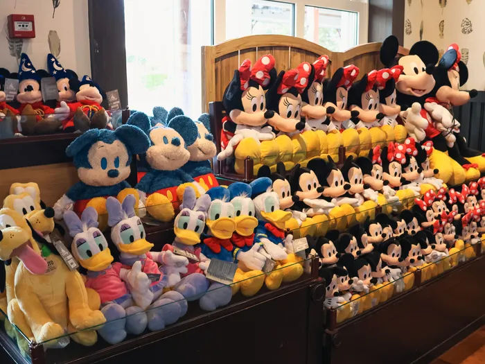 Tiered display of Disney soft toys (Mickey, Minnie, Donald and Pluto) in the General Store shop.