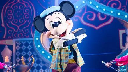 Mickey en gilet à carreaux sur scène pendant le spectacle Mickey et le Magicien à Disneyland Paris