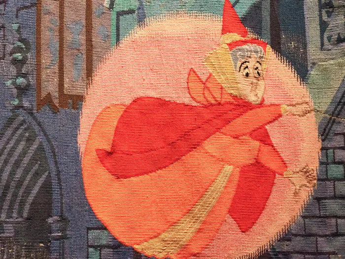 Détail de tapisserie montrant la fée Flora en robe rouge, dans la Galerie de la Belle au Bois Dormant.