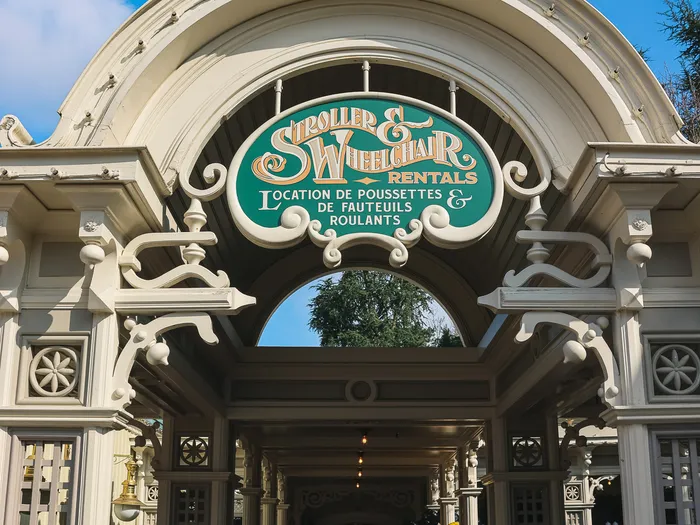 Pushchair and wheelchair hire point at Disneyland Paris, under its ornate entrance pavilion.