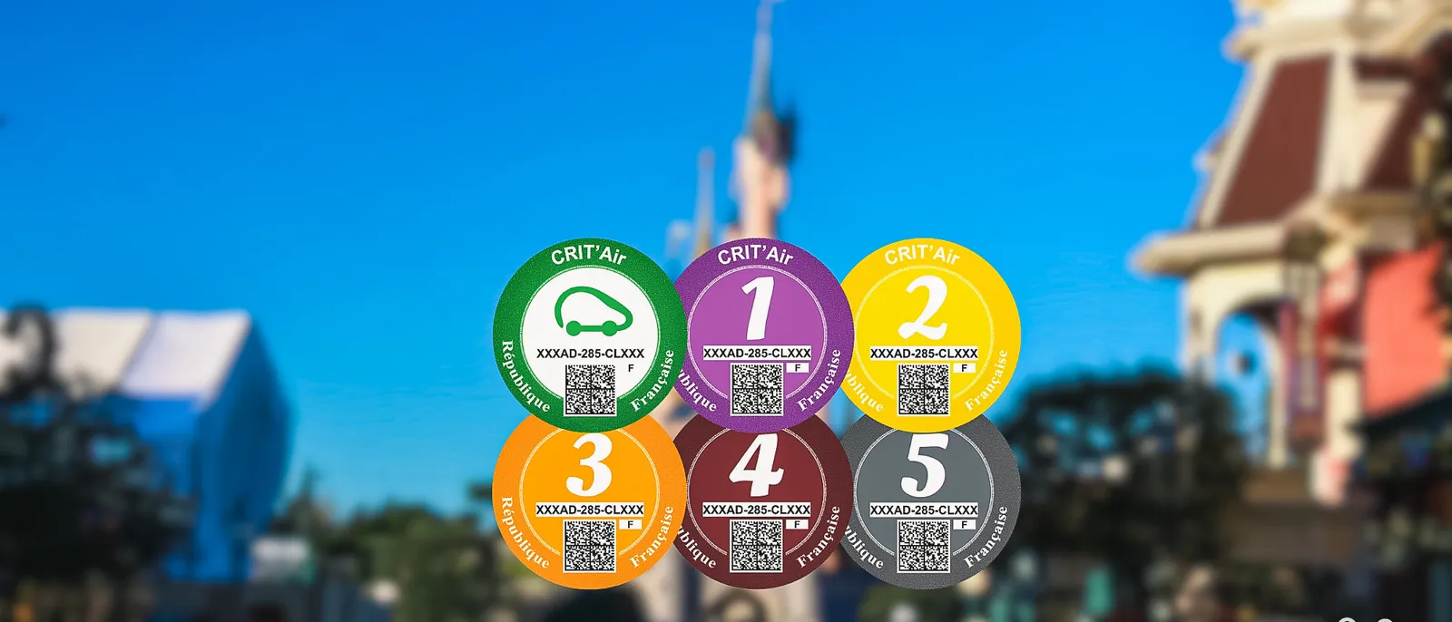 Les six pastilles Crit’Air, du vert au gris, disposées en fleur devant le château de Disneyland Paris flouté.