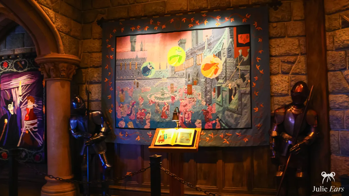Tapestry of the three good fairies above the crowd, between two suits of armour, in La Galerie de la Belle au Bois Dormant at Disneyland Park
