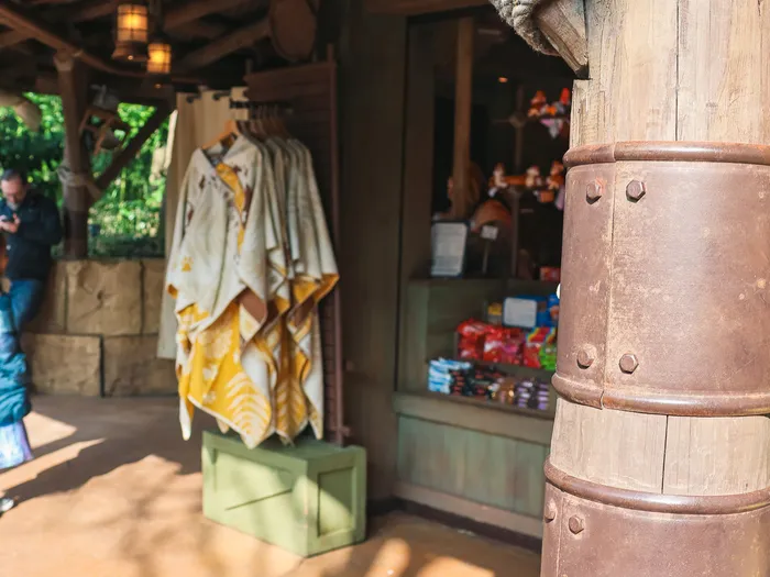 Wooden structure of Temple Traders Boutique, a rope-wrapped post and printed clothes on display