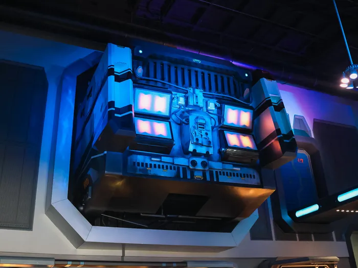 Spaceport decor on the Star Traders ceiling, with illuminated screens and droid details