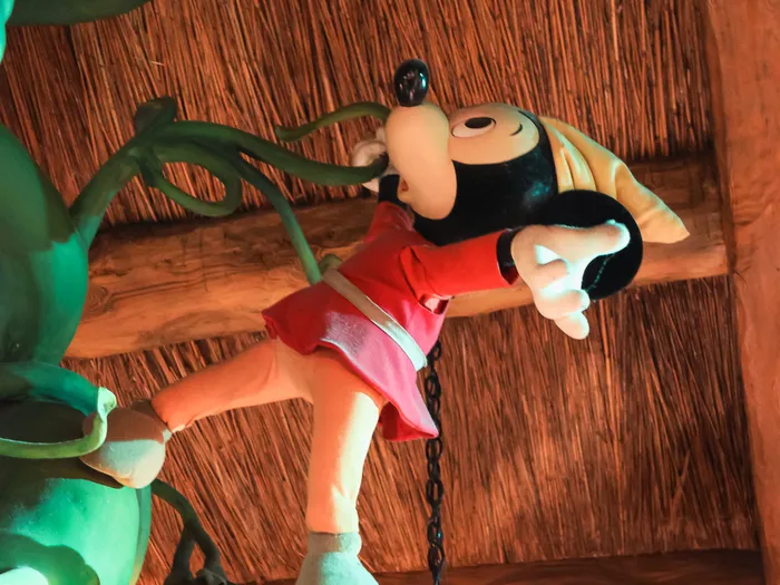 Knight Mickey soft toy clinging to the giant beanstalk, under the shop’s beams