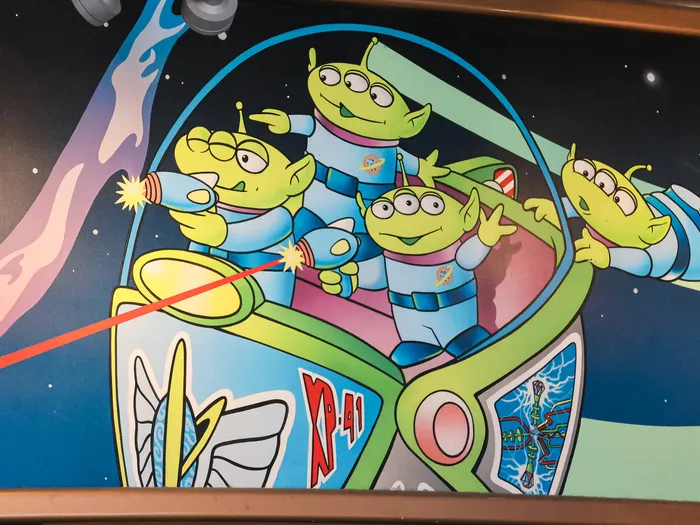 Mural detail: green Toy Story aliens aboard Buzz Lightyear’s spaceship