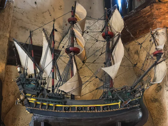 Model galleon under sail hanging on the wooden wall inside the Le Coffre du Capitaine shop at Disneyland Paris