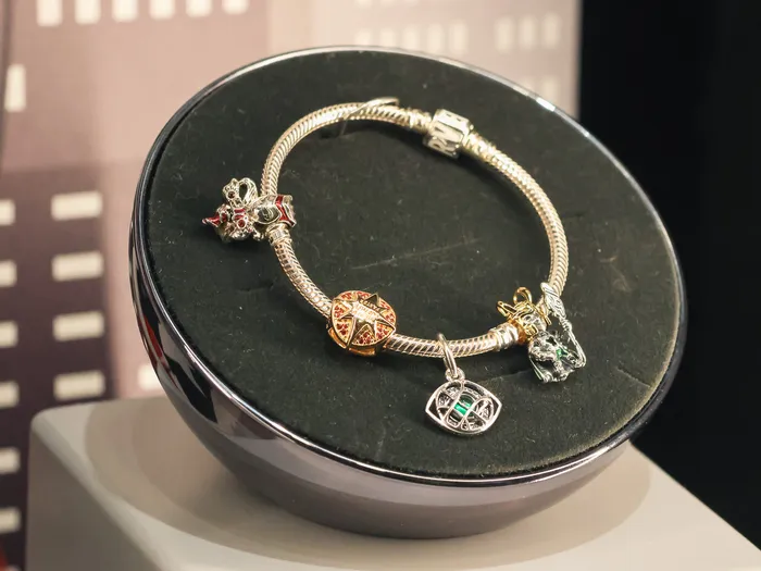 Silver Pandora bracelet decorated with colourful charms on a display at the New York Boutique