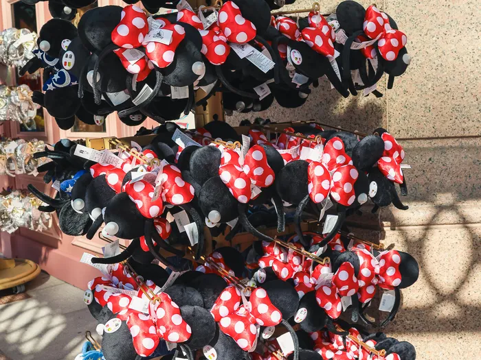 Rotating display of Minnie ear headbands with red polka-dot bows, Plaza East Boutique