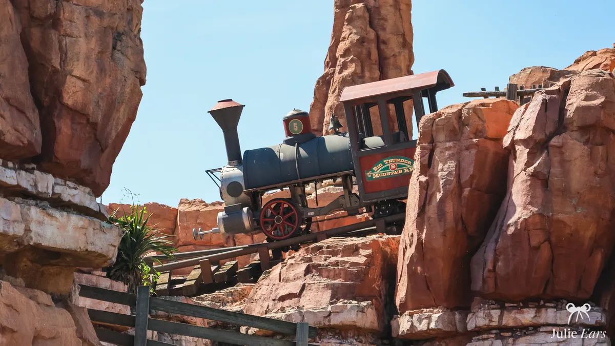 Big Thunder Mountain locomotive No. 5 at Disneyland Paris, its red cab marked "Big Thunder Mountain R.R.", on a sloping track between red rocks