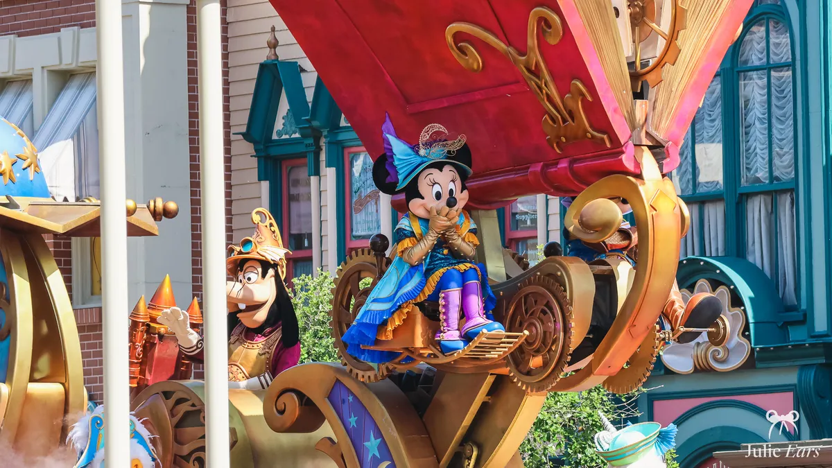 Minnie in a magician’s costume, with a pointed blue hat and purple boots, on the final float of Disney Stars on Parade at Disneyland Paris