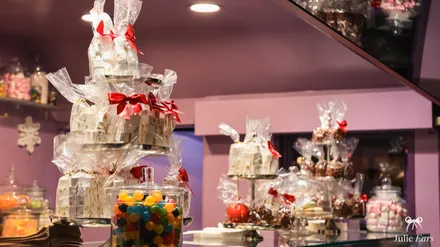 Sweets chalet at the food festival: bags of marshmallows tied with red ribbons, jars of colourful sweets and chocolates.