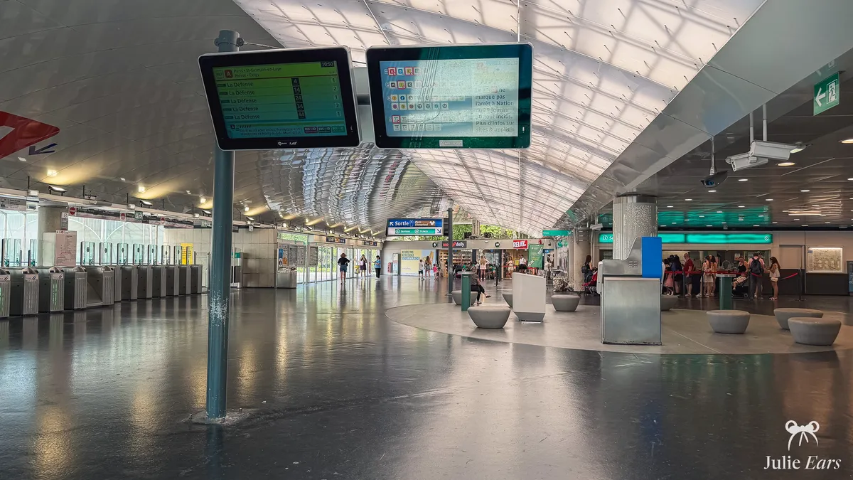 RER hall of Marne-la-Vallée/Chessy station near Disneyland Paris, with RER A screens, ticket gates on the left and ticket windows on the right