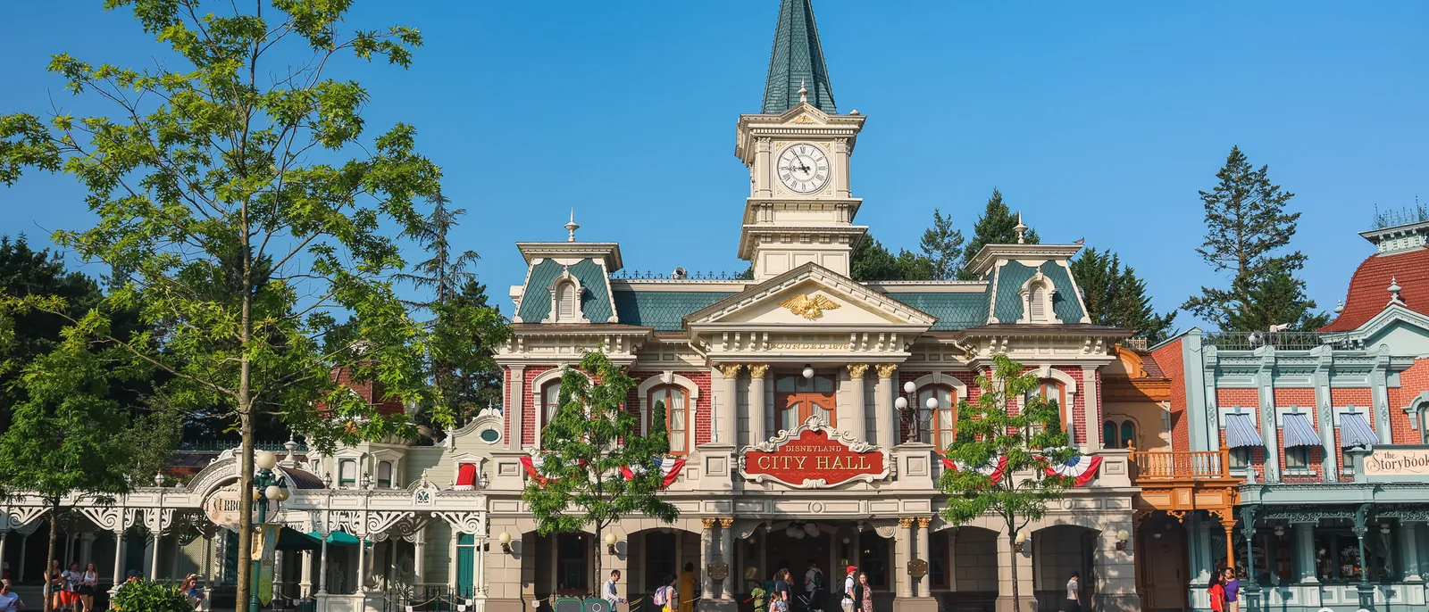 City Hall et son horloge sur Main Street USA, façade fleurie sous un ciel bleu au Parc Disneyland.
