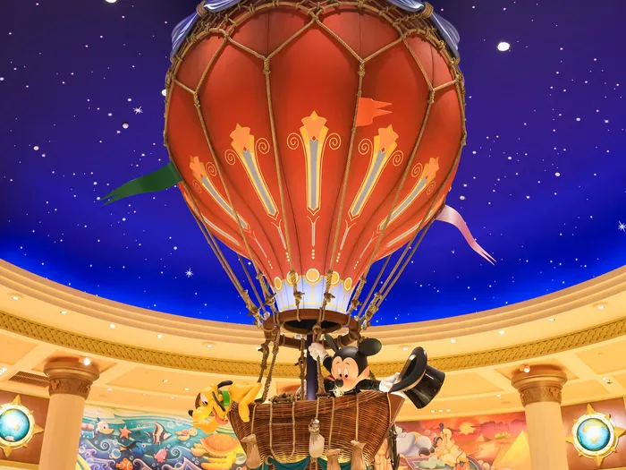 Large decorative hot air balloon hanging from the starry ceiling in the centre of the shop at Disneyland Paris.