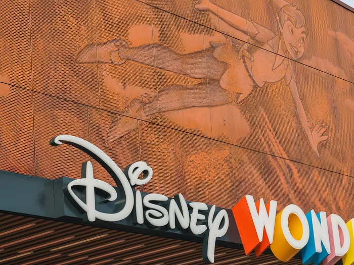 Peter Pan engraved on the copper facade of the Disney Wonders shop, above the sign with colourful letters.