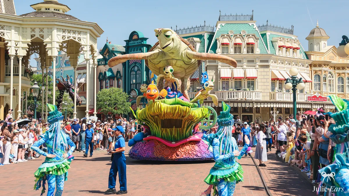 Finding Nemo float in Disney Stars on Parade, with Crush, Nemo, Squirt and Dory, passing the Town Square bandstand at Disneyland Paris