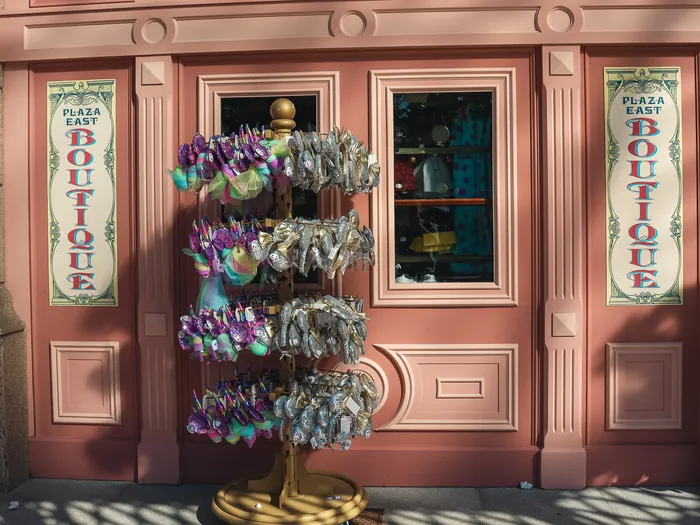 Pink facade of the Plaza East Boutique with a display of colourful Minnie ear headbands