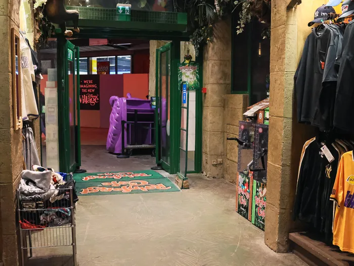 Shop aisle lined with basketball jerseys and caps at Disney Village