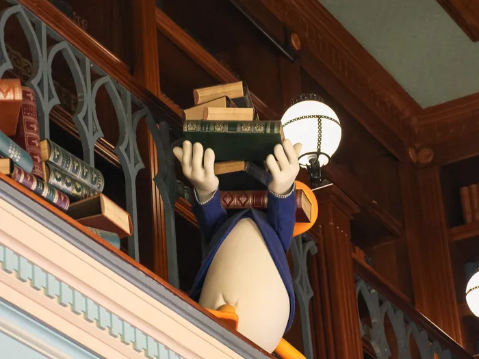 Donald figure holding a pile of books in The Storybook Store