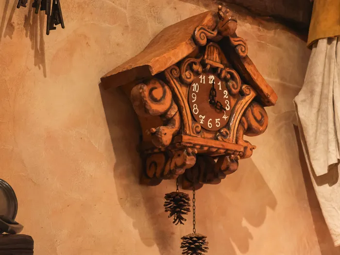 Carved wooden clock in La Chaumière des Sept Nains at Disneyland Paris.