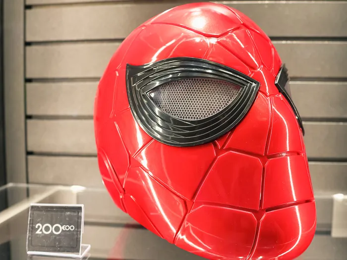 Red and black Spider-Man mask displayed in a glass case at the New York Boutique