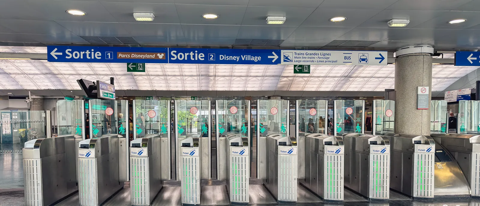 Portillons de la gare RER A Marne-la-Vallée Chessy avec les panneaux Sortie Parcs Disneyland