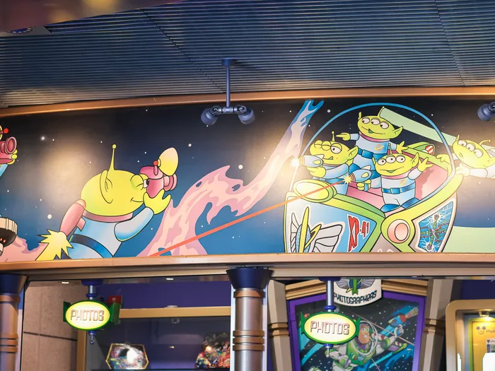 Large space mural at the Star Command Photographers photo spot, with the green aliens from Toy Story