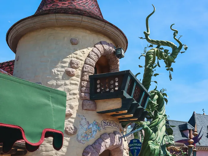 Front of Sir Mickey’s Boutique with its giant green beanstalk climbing the stone tower