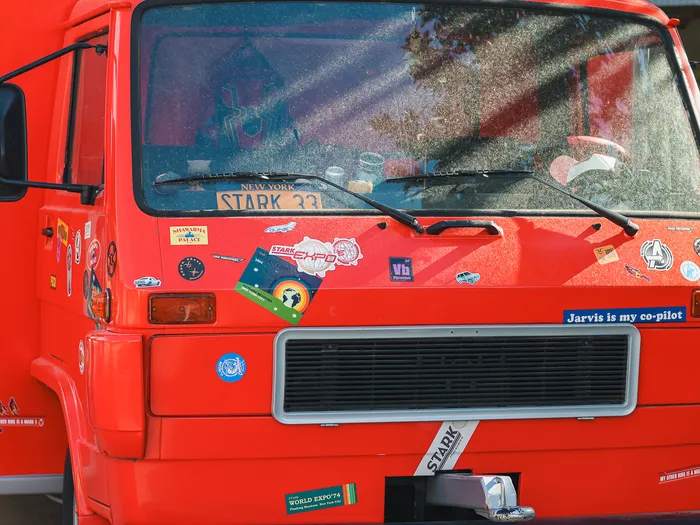Front of the FAN-tastic Food Truck at Disneyland Paris: red truck with New York plate STARK 336 and a "Jarvis is my co-pilot" plate on the bumper