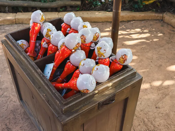Red and white bubble blowers stored in a wooden crate at Disneyland Paris