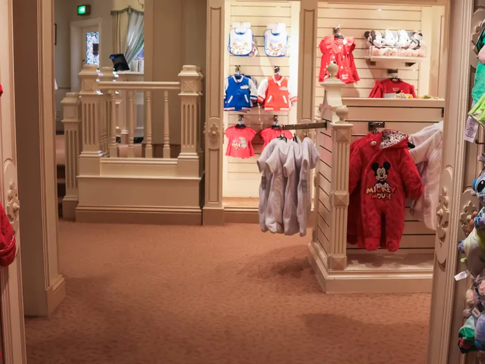 Baby clothes corner at Disney Clothiers at Disneyland Paris, in the shop’s white Victorian setting.