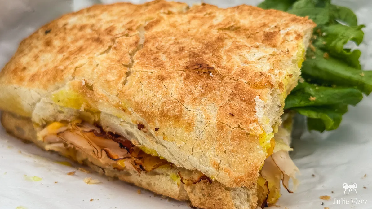Hot sandwich with golden, crispy bread served with salad at Earl of Sandwich, Disney Village.