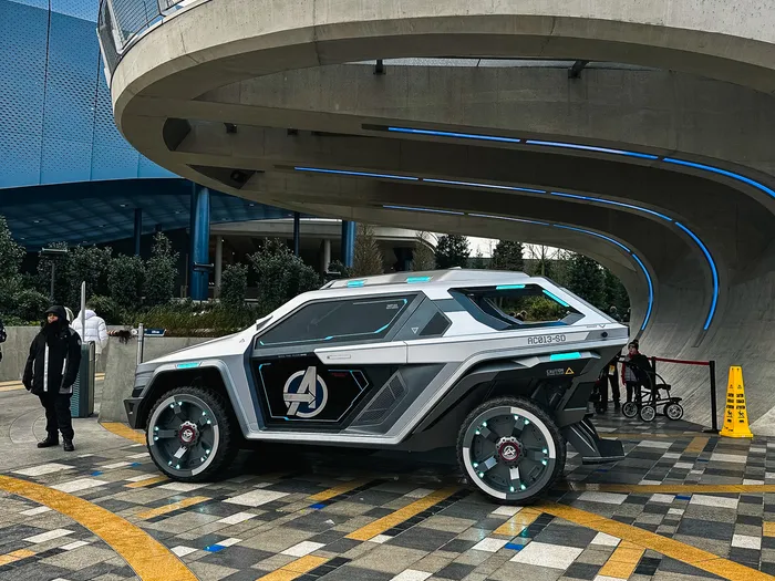 Véhicule blindé gris au logo des Avengers garé sous la rampe en béton de Marvel Avengers Campus.