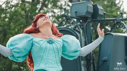 Princess Ariel, in her turquoise dress, mid-song during World Princess Week at Disneyland Paris.